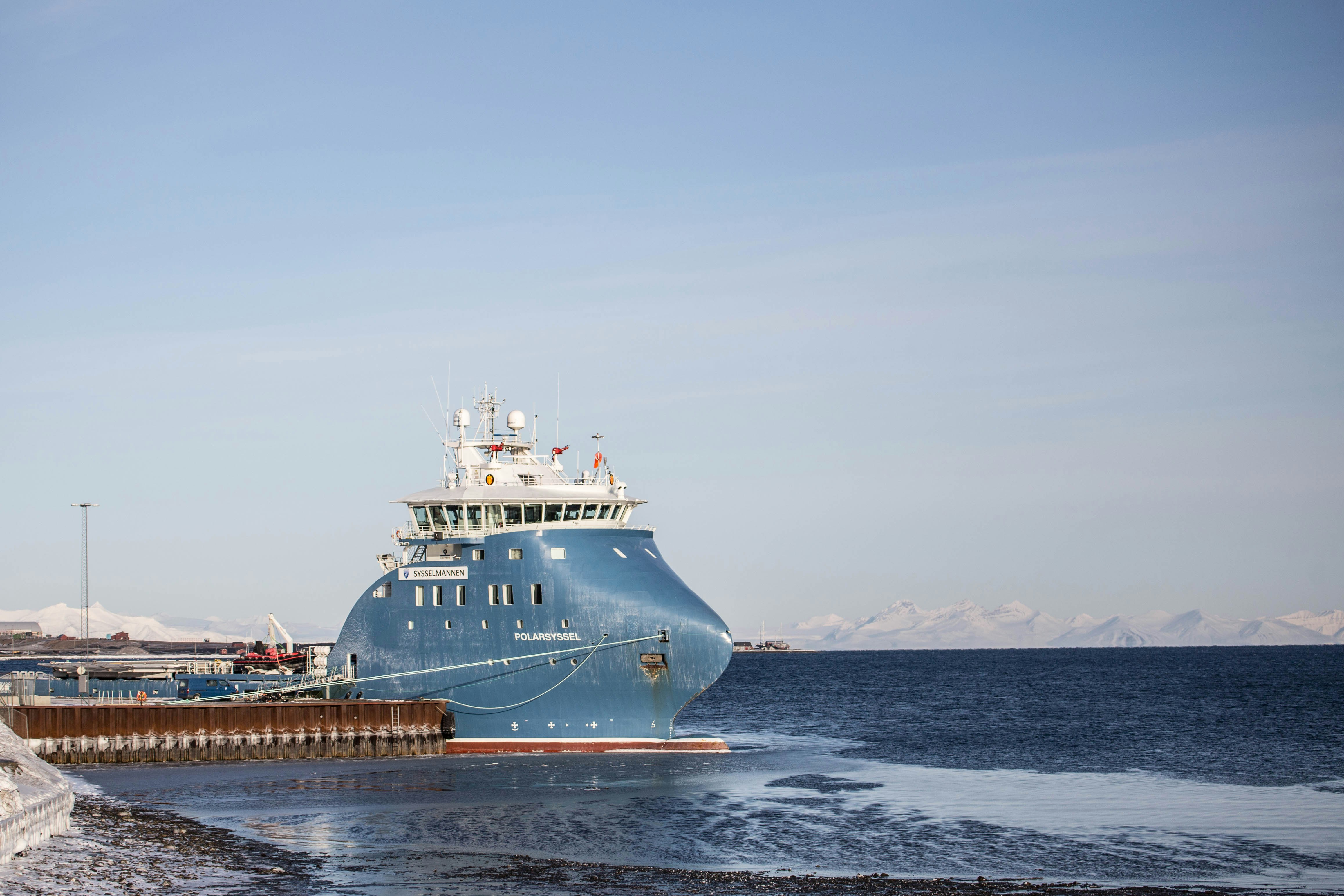 white and blue ship on sea